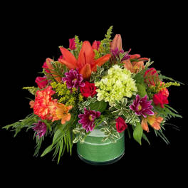 Colorful mixed flower arrangement in a green vase