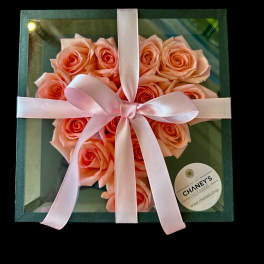 Boxed peach roses tied with a pink ribbon