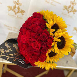 Bouquet of red roses and yellow sunflowers with a black card