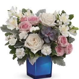 Pink and white roses with alstroemeria in a blue vase