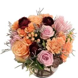 Mixed roses and carnations in a clear glass vase