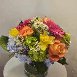 Colorful mixed flower arrangement in a glass vase