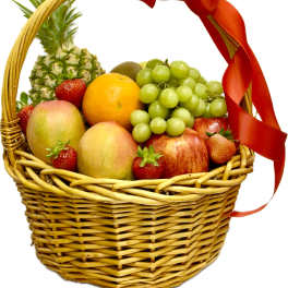 Fruit basket with pineapple, grapes, apples, oranges, mangoes, and strawberries