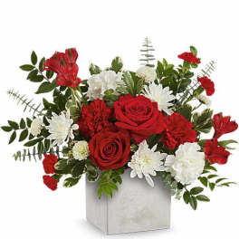 Red roses and white daisies in a square vase
