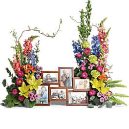 Colorful floral display with framed photos arranged in the center