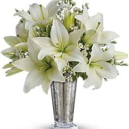 White lilies arranged in a silver vase