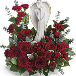 Red rose arrangement with a white angel statue centerpiece