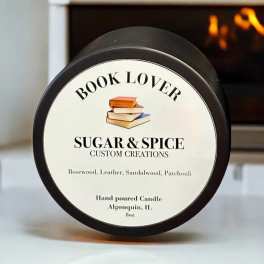 A black-lidded candle jar with a book-themed label.