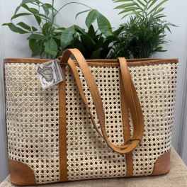Woven tote bag with tan leather straps and trim