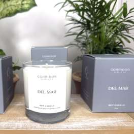 Soy candle in a glass jar with two matching boxes beside it