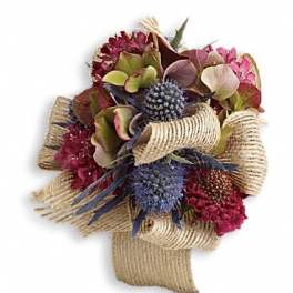 Bouquet of pink and burgundy flowers wrapped in burlap