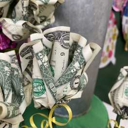 Bouquet made of folded dollar bills with yellow ribbon curls