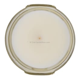 Round white candle in a clear glass jar