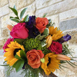 Hand-tied bouquet with roses, sunflowers, and lilies