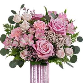 Pink roses and alstroemeria in a tall striped vase