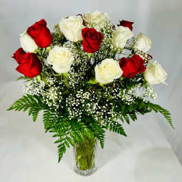 Red and white roses in a clear glass vase