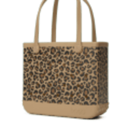 Tan tote bag with leopard print panel and long matching handles on a plain background