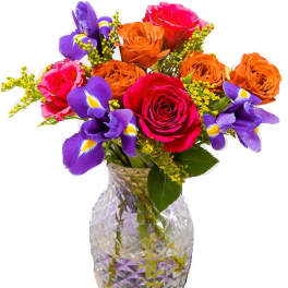 Bouquet of roses and purple irises in a cut-glass vase