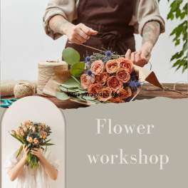 Person arranging a peach rose bouquet at a flower workshop