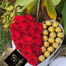 Heart-shaped box with red roses and gold-wrapped chocolates