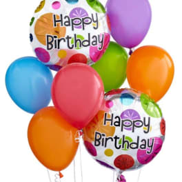 Cluster of colorful birthday balloons, including two "Happy Birthday" foil balloons