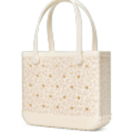 Cream tote bag with cutout floral pattern and long handles