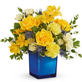 Yellow and white roses with yellow alstroemeria in a blue vase