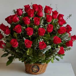 Basket arrangement of red roses with eucalyptus foliage