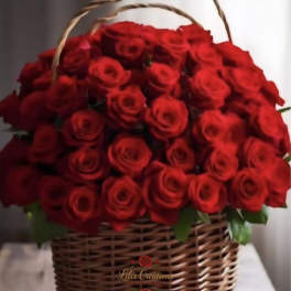 Basket of red roses with green leaves