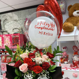 Red and pink rose bouquet with a birthday balloon