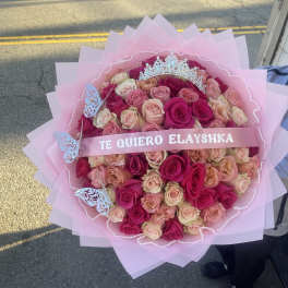 Large pink bouquet of roses with a tiara and ribbon