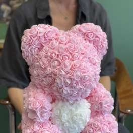 Pink rose teddy bear with a white heart on its chest