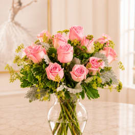 Pink roses arranged in a clear glass vase