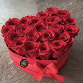 Heart-shaped box of red roses tied with a red ribbon