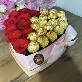 Heart-shaped box with red roses and gold-wrapped chocolates