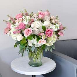Pink and white rose bouquet in a glass vase