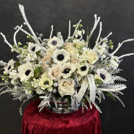White and blush bouquet with anemones and roses in a silver vase