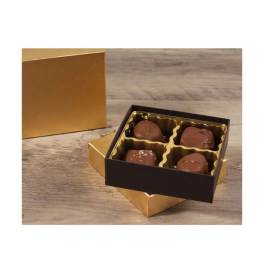 Box of four chocolate truffles in a gold tray