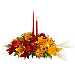 Autumn floral centerpiece with two red candles and yellow flowers