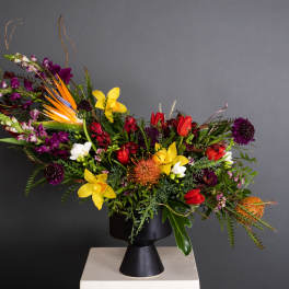 Colorful mixed bouquet in a black pedestal vase