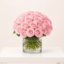 Pink roses arranged in a clear glass vase