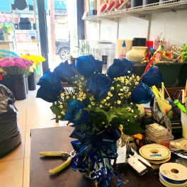 Bouquet of blue roses with baby's breath and a ribbon bow