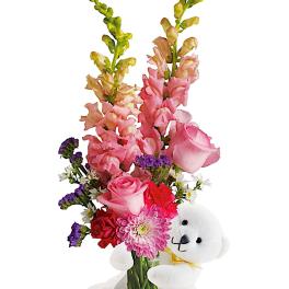 Pink and purple flower bouquet with a white teddy bear
