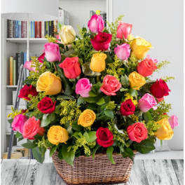 Basket of multicolored roses with yellow filler flowers