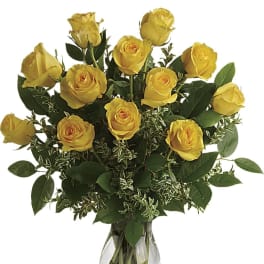Yellow roses arranged in a clear glass vase