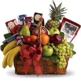 Gift basket with fruit, cheese, crackers, and chocolates