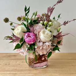 Pink and white floral arrangement in a clear glass vase