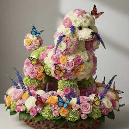 Floral dog sculpture in a wicker basket with butterflies