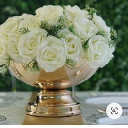 White rose arrangement in a gold pedestal vase