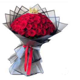 Bouquet of red roses wrapped in black paper with a red ribbon